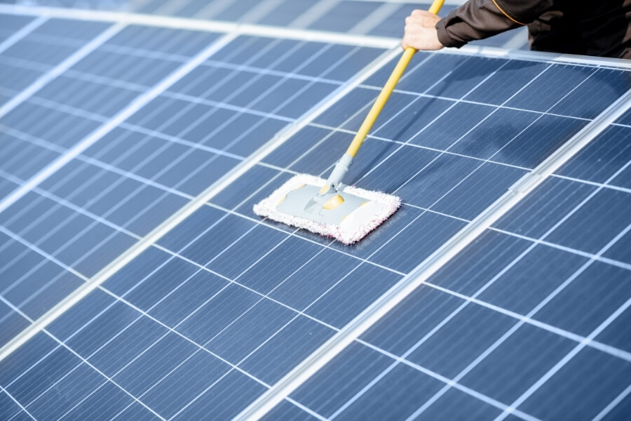 Worker Cleaning Solar Panels